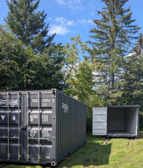 Two shipping containers parked side by side